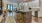 Spacious and well lit kitchen with wood flooring and stainless steel appliances